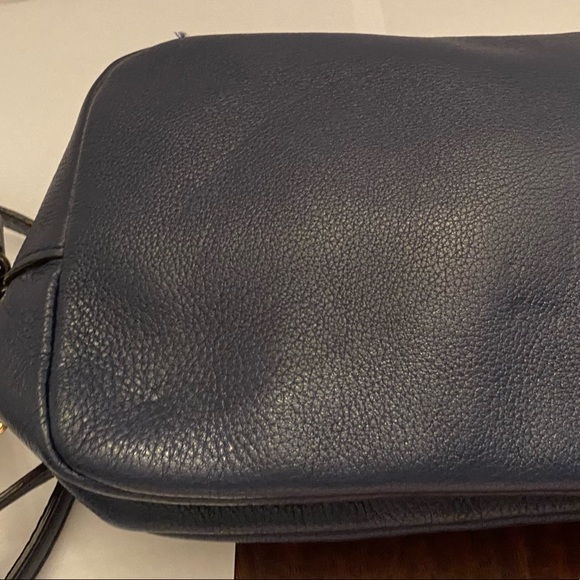 This genuine leather zip up purse is a dark navy blue. - Picture 2 of 7